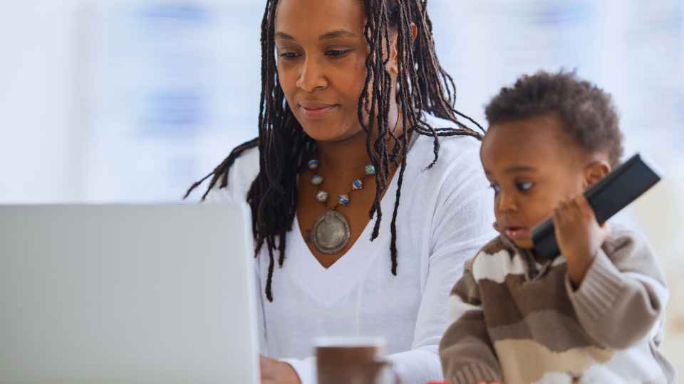 A single mom with her son working on her laptop to start a business